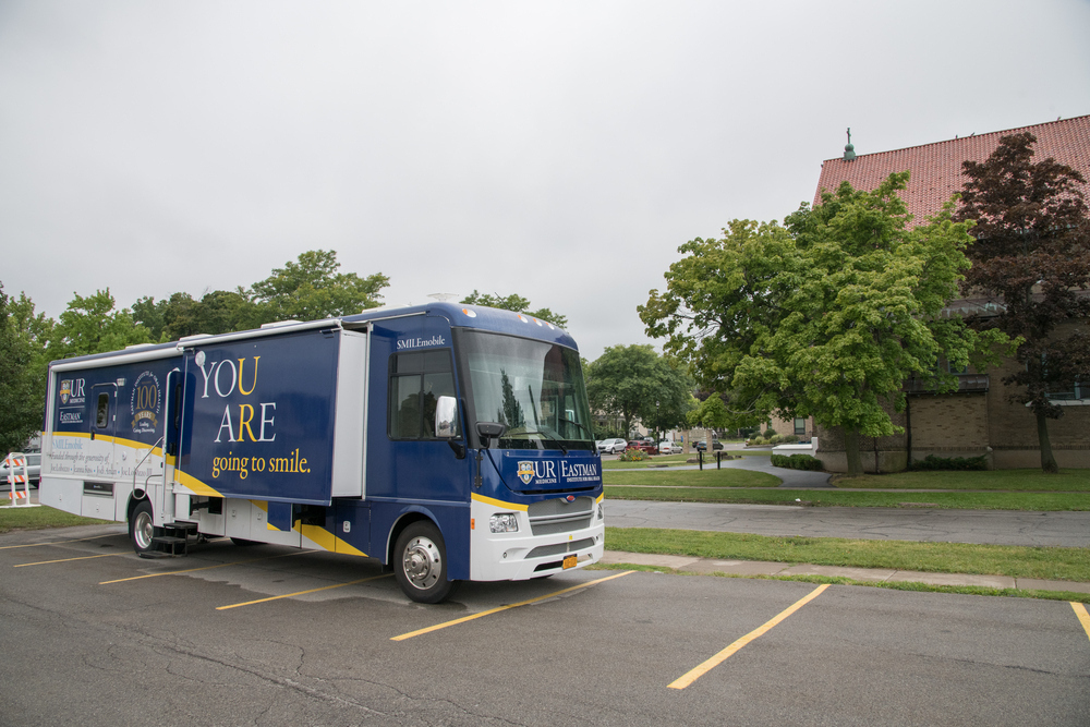 A SMILEmobile parked next to a building.