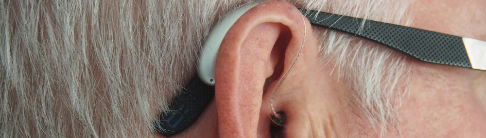 close up of a man's hearing aid on his hear