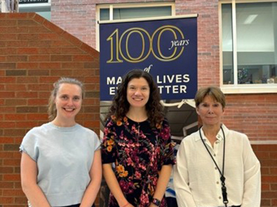 Group photo in front of 100 years of URochester Medicine banner