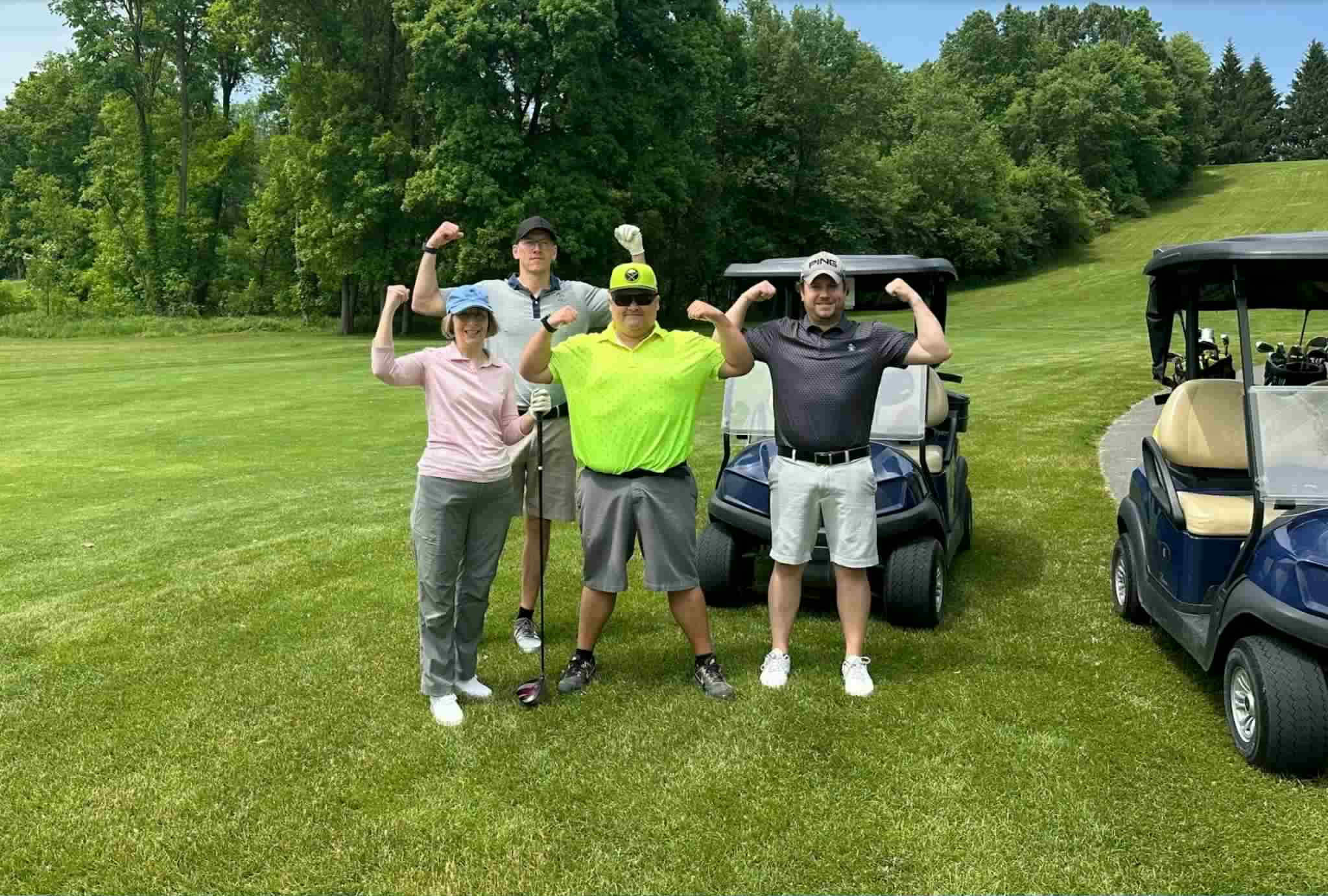 Team members participating in the Palmesano Strong Golf Tournament.