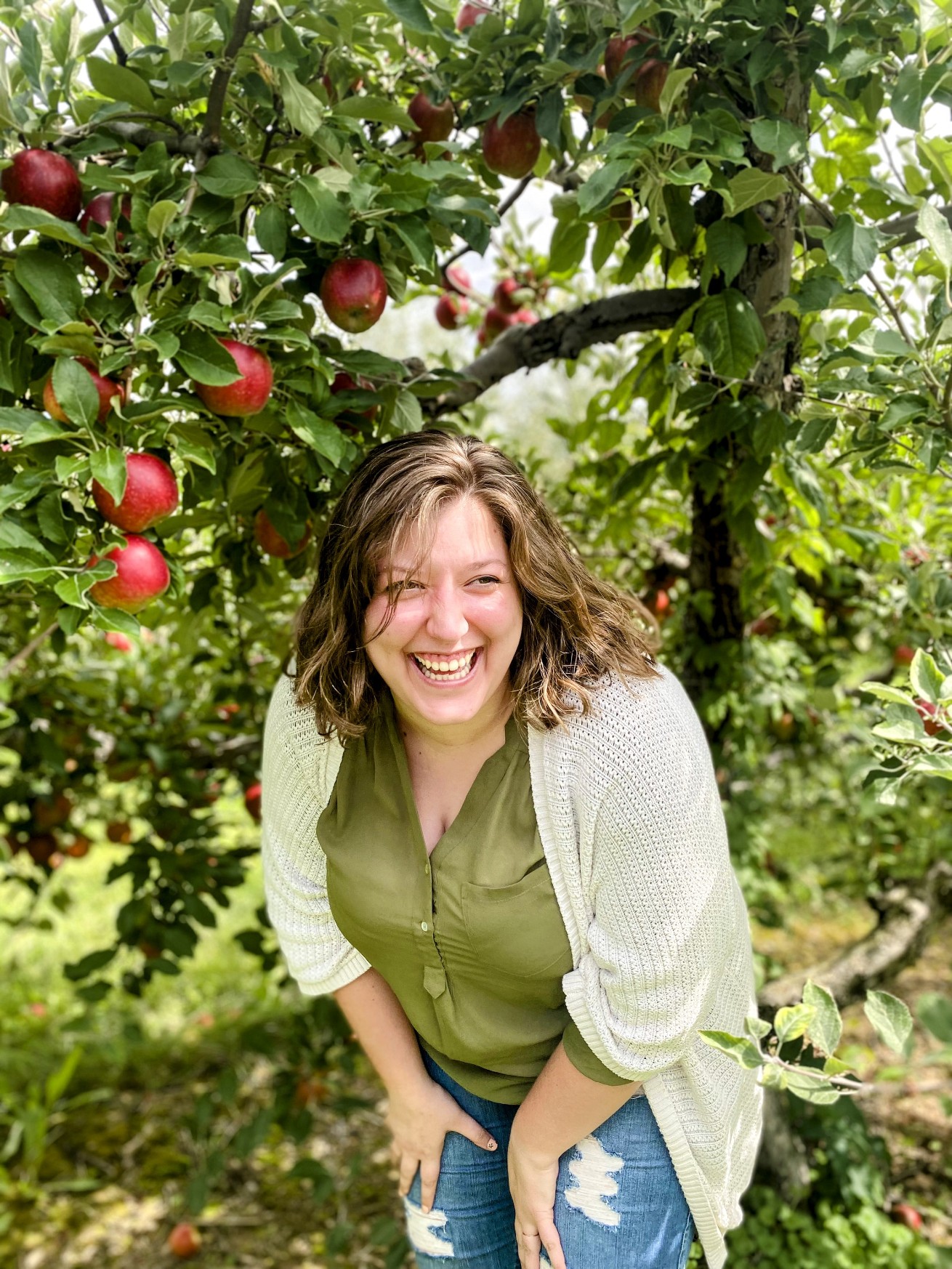 A team member apple picking during a fall outing.