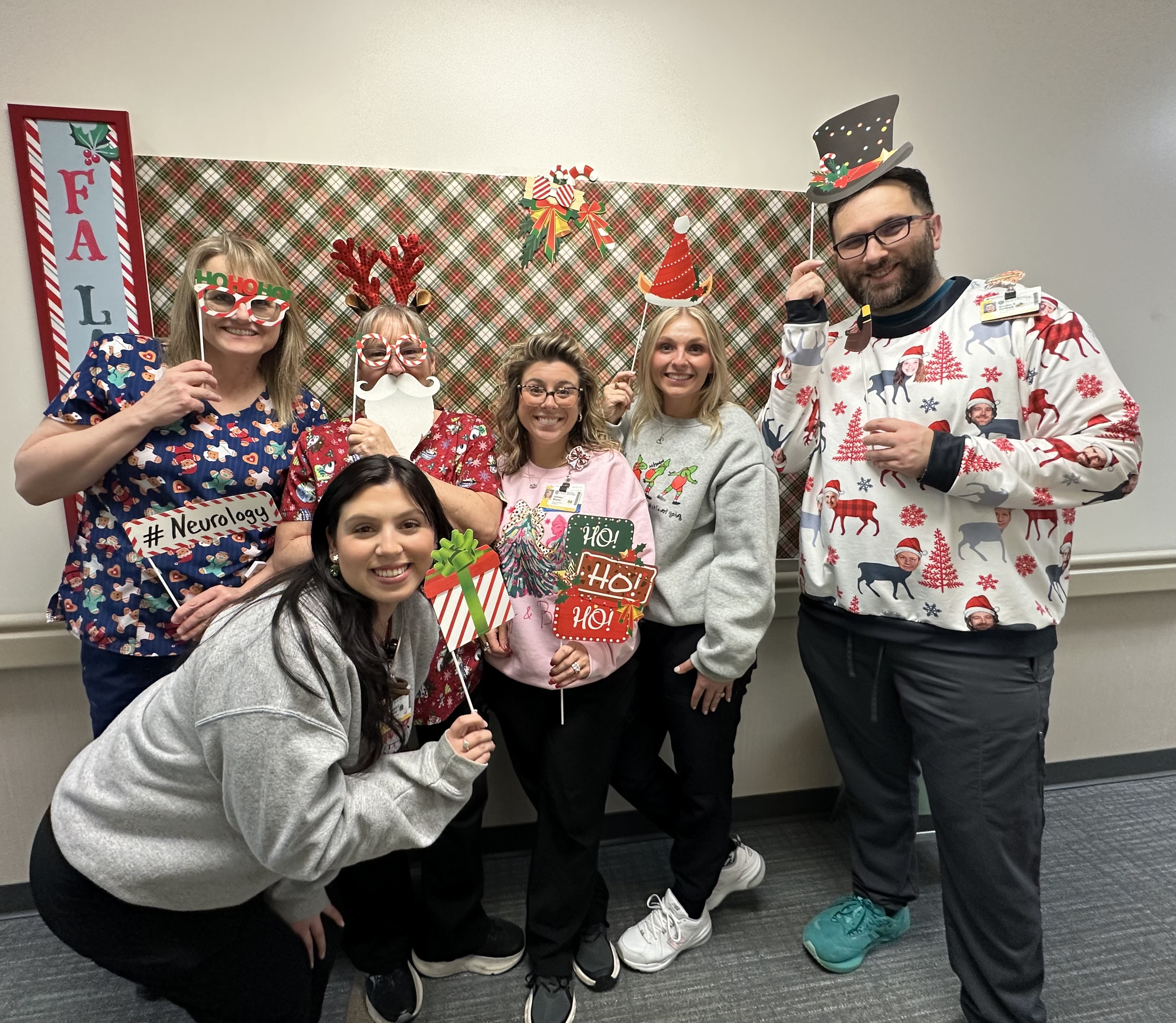 Neuromuscular team members posing together at the holiday celebration.