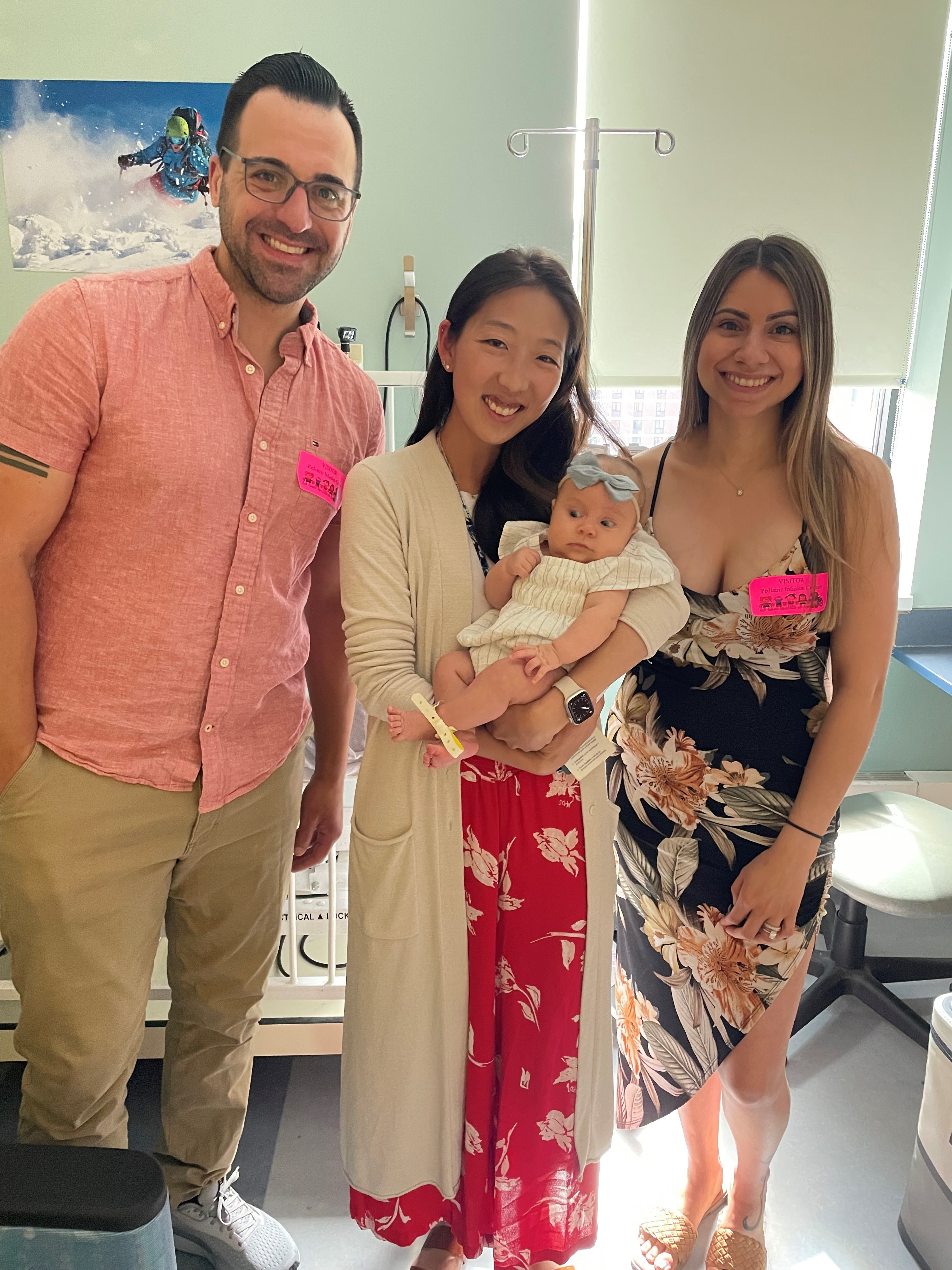 Dr. Bo Lee with a baby participating in Duchenne muscular dystrophy research