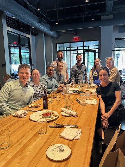 Colleagues enjoying dinner together.