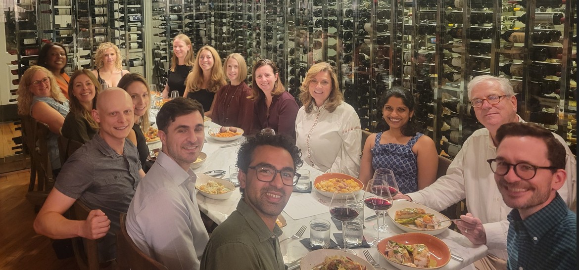 REI Division sits together at a long table