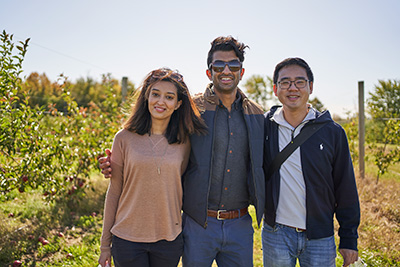 Three Residents Standing in a Vineyard