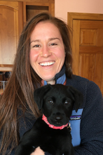 Logan Todhunter with her black lab puppy