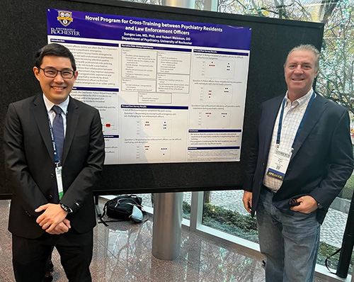 resident and faculty at poster session