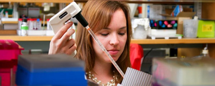 Student with pipette in lab