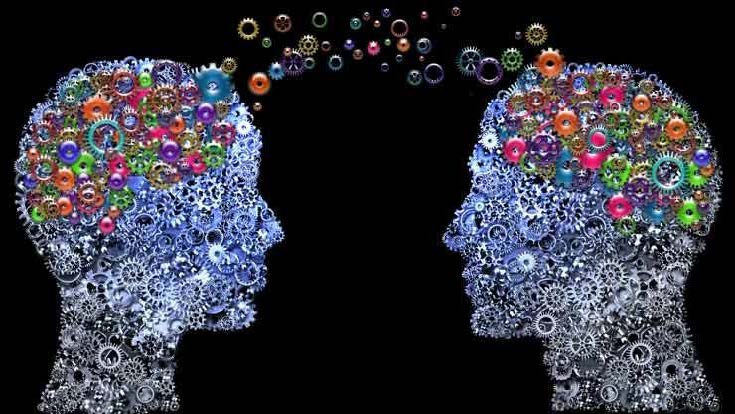 two heads made up of colorful small gears facing each other