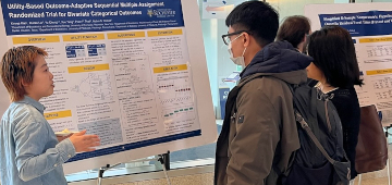 Students discussing poster