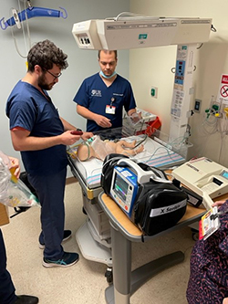 Fellows practicing on a baby simulator