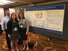 Residents presenting poster at conference