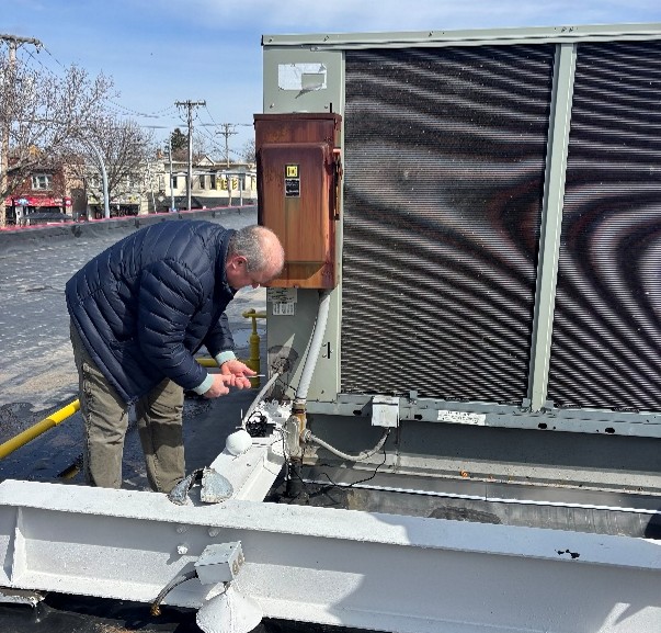 worker installing an air sensor