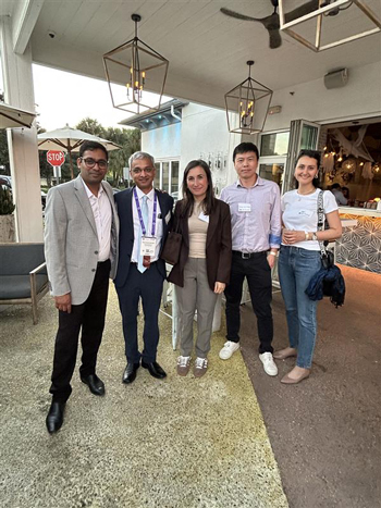 Group of attendees at Flaum reception posing for a group picture.