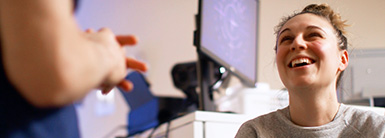Woman smiling and talking with a doctor