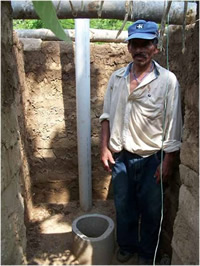 Man standing next to latrine