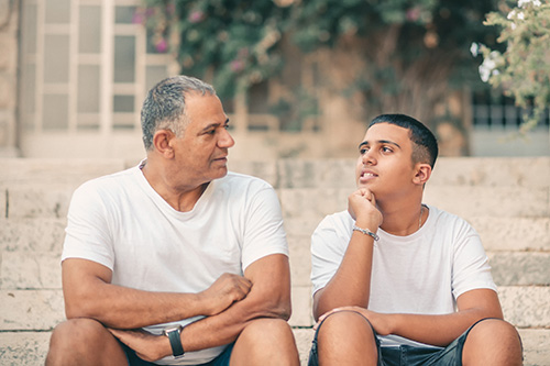 older man talking to young boy