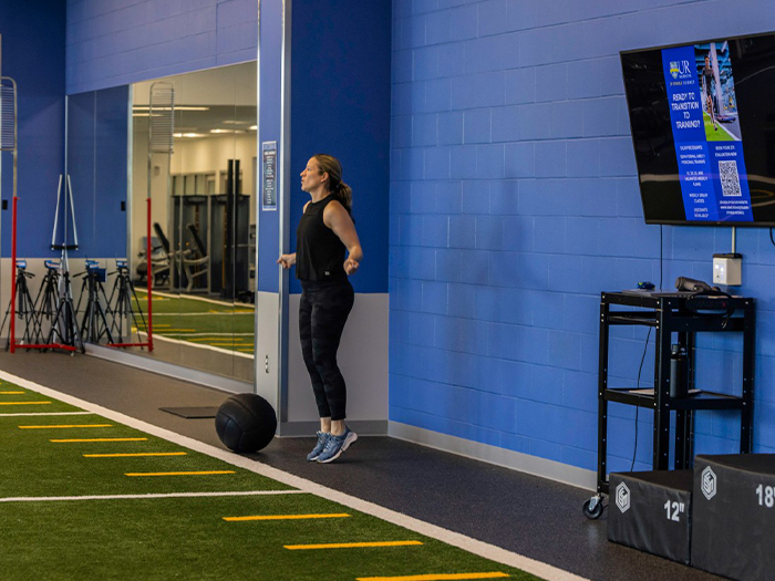 Women in gym doing an active movement warm-up