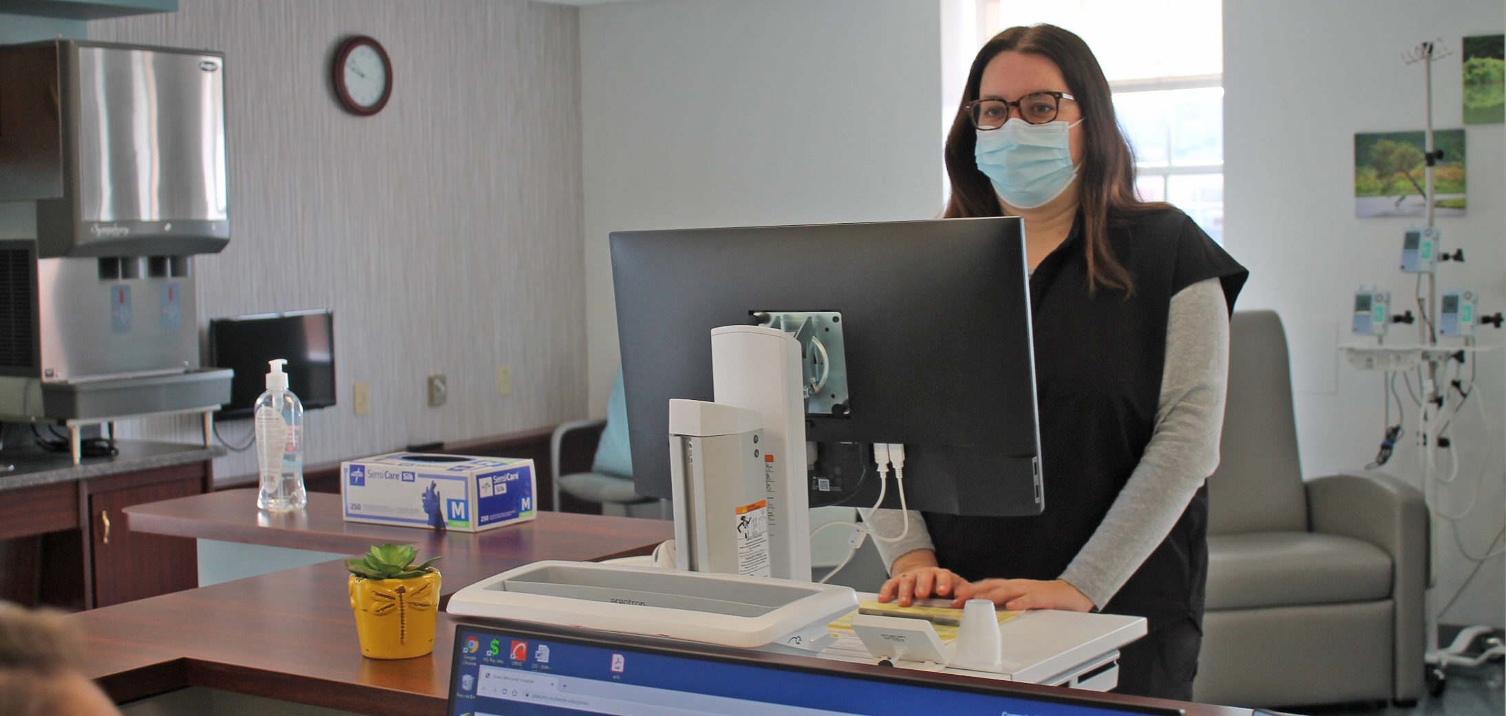 Provider working at a computer station in the infusion center.