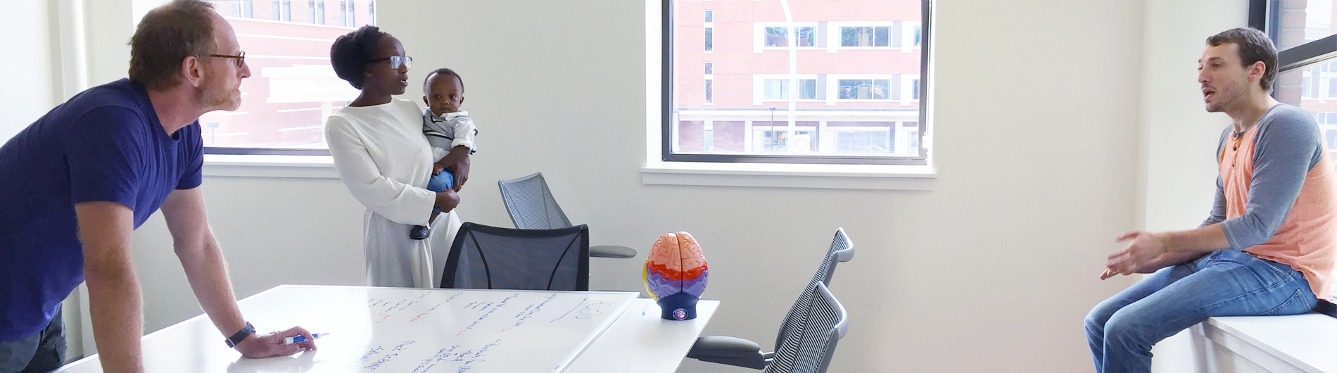 discussion between lab members and mother with child