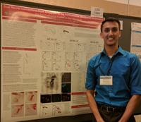 Photo of Keshov Sharma in front of a scientific poster at a conference in San Diego