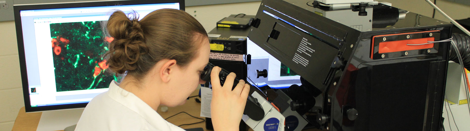 Photo of technician working on confocal microscope