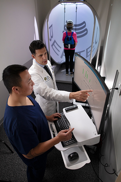 Dr. Haddas and colleague reviewing mobility test with a patient.