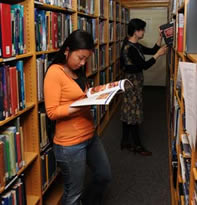 Student reading a book in the Bibby stacks