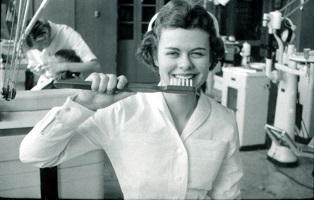 Dental Hygienist (name unknown) with oversized toothbrush