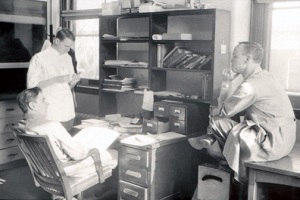 Dr. Emmett Costich (Pathologist) with Drs. Caldwell and Ellwood studying together in the Eastman Dental Dispensary.