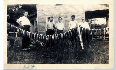 Hofschneider standing with friends and fishing lures