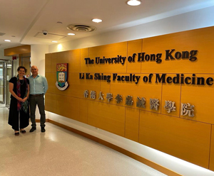 Dr. Luck in front of welcome sign at University of Hong Kong