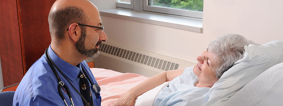 Dr. Daniel Mendelson visits with patient