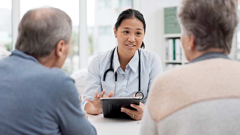 doctor talking with a senior couple