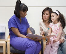 Nurse talking with mother and daughter
