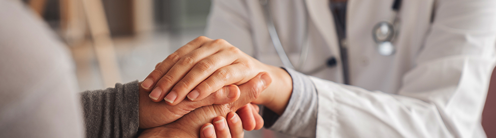 Doctor holding a patient's hand
