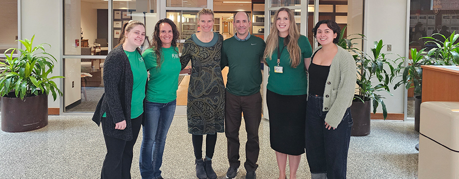 Group photo of REACH-DM team wearing green