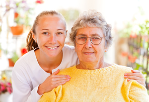 Elderly woman with caregiver