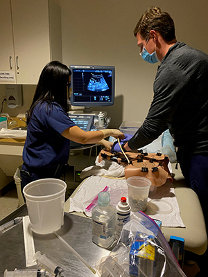 MFM fellows Dr. Mather & Dr. Liew simulating & learning amniocentesis with Dr. Drennan