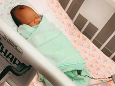 pre-term baby in hospital crib