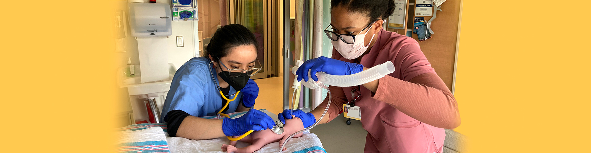 Neonatology fellows with a simulation mannequin