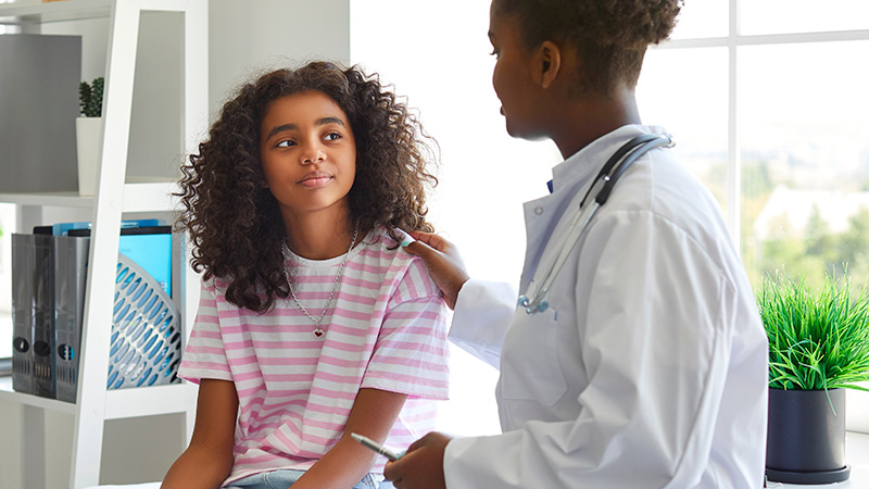 doctor talking with teen girl