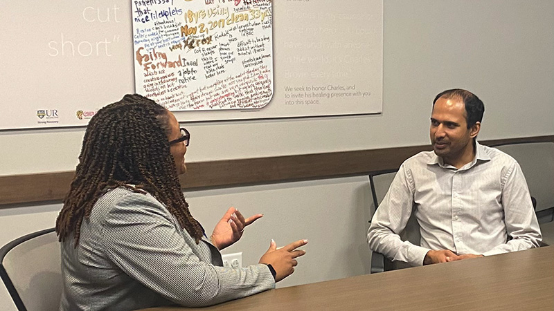 Dr. Mathis talking with fellow