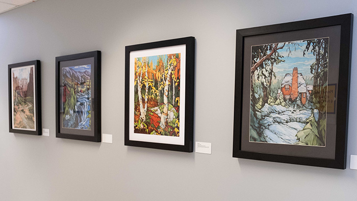 four framed artwork pieces hung on the hall of the Bridge Art Gallery
