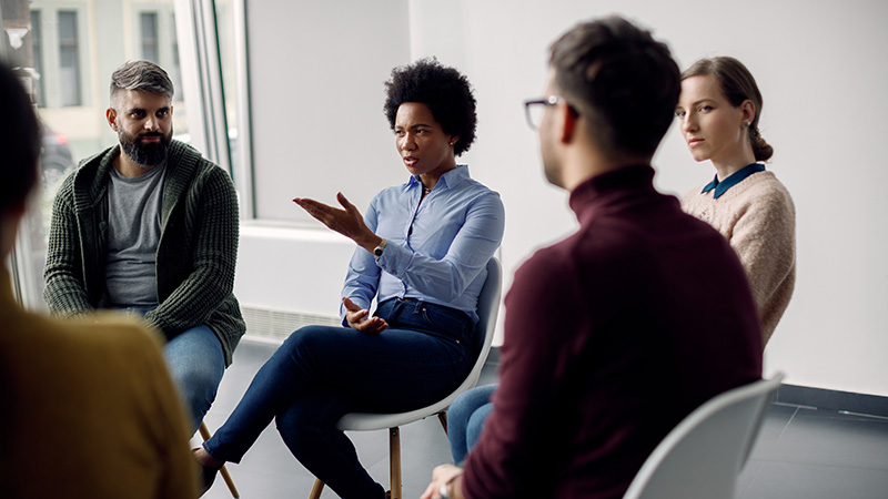 group of people talking in a circle