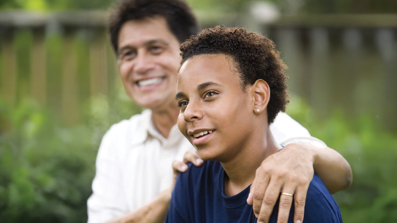 father encouraging teen son