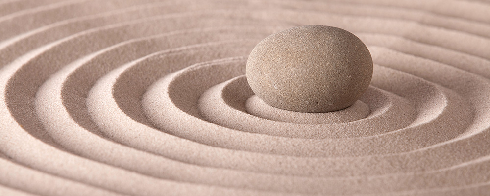rings of sand with a stone set in the middle