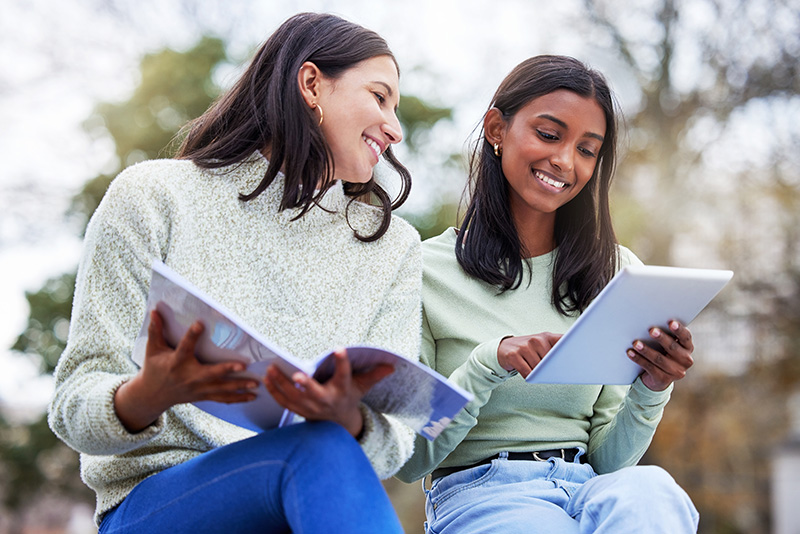 two college students looking at a tablet