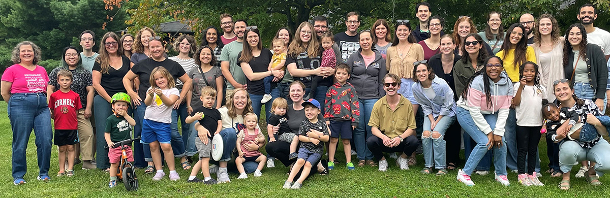 Large group of faculty, interns and fellows in park
